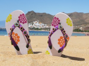 flip-flops-in-sand_shutterstock_59813551